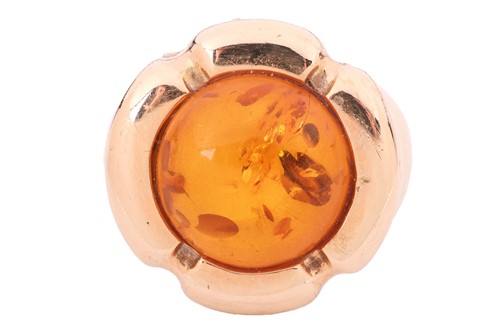 Lot An amber cabochon dress ring, centred with a...