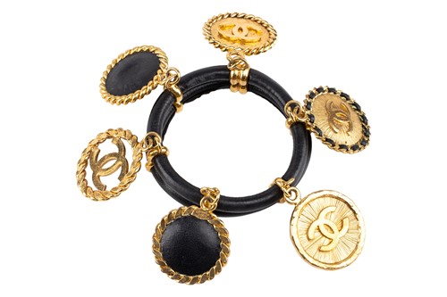 Lot 142 - Chanel - a 1992 padded black leather bangle,...