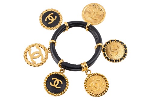 Lot 142 - Chanel - a 1992 padded black leather bangle,...