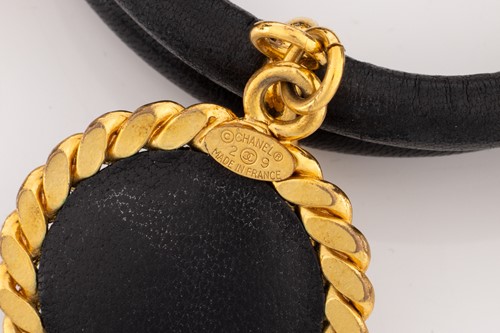 Lot 142 - Chanel - a 1992 padded black leather bangle,...