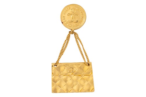 Lot 144 - Chanel - a brooch suspending a classic flap...