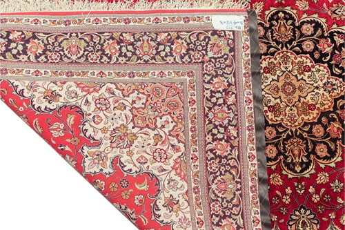 Lot 293 - A claret ground room size Qum silk on silk...