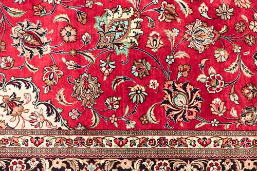 Lot 293 - A claret ground room size Qum silk on silk...