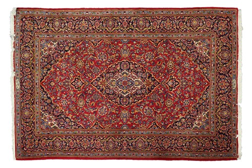 Lot 292 - A red ground Kashan rug with central mandorla...