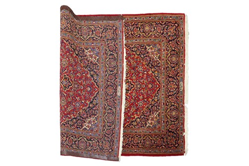 Lot 292 - A red ground Kashan rug with central mandorla...