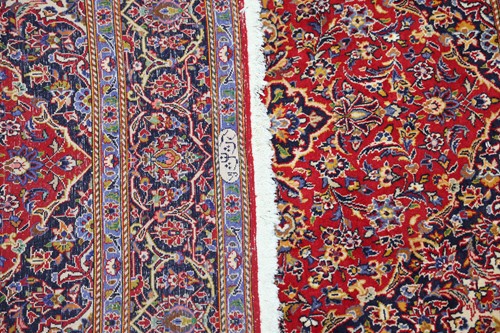 Lot 292 - A red ground Kashan rug with central mandorla...