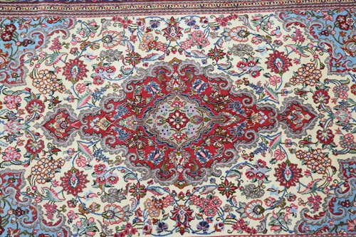 Lot 288 - An ivory ground Kerman carpet with a flower...