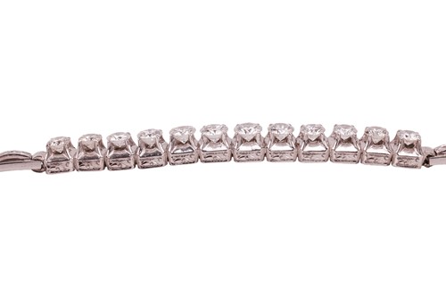 Lot 64 - A diamond-set bracelet, claw-set with twelve...