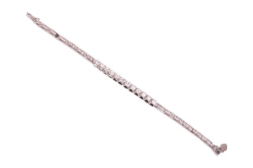 Lot 64 - A diamond-set bracelet, claw-set with twelve...