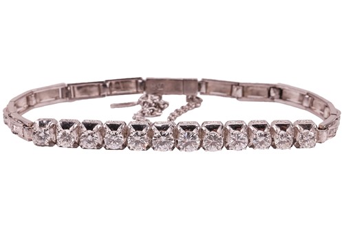 Lot 64 - A diamond-set bracelet, claw-set with twelve...