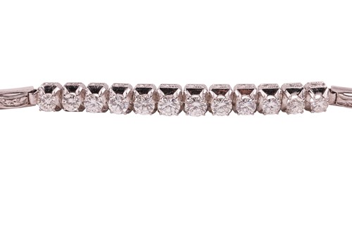 Lot 64 - A diamond-set bracelet, claw-set with twelve...