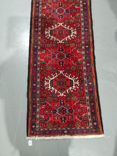 Lot 147 - A red ground Karaja strip runner with nice...