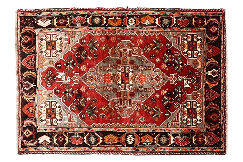 Lot 294 - A plum-coloured ground Baktiari rug with a...