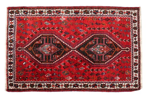 Lot 286 - A red ground Qashqai rug with two diamond...