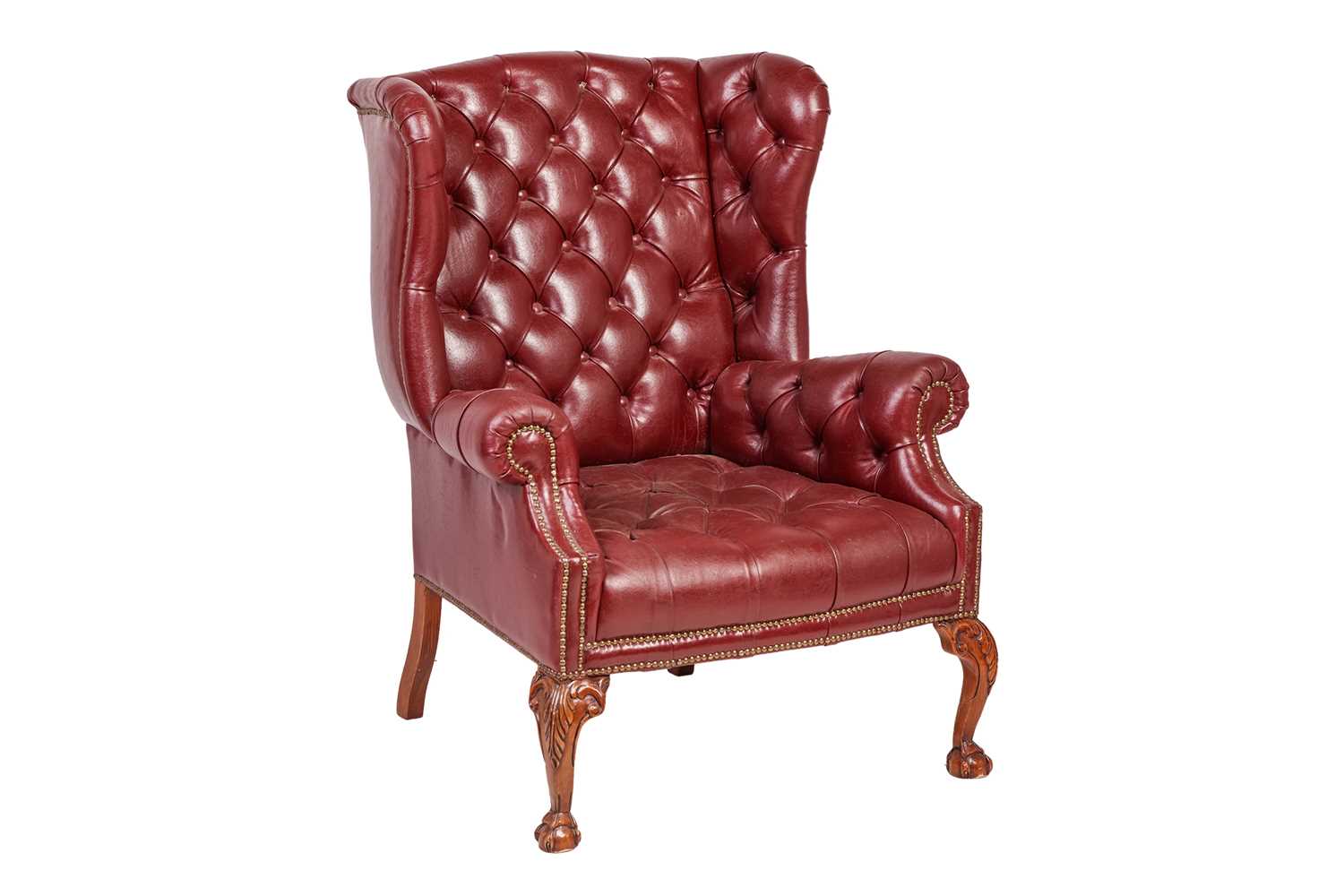 Lot 251 - A George III style deep buttoned hide fireside...