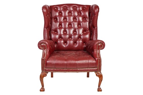 Lot 251 - A George III style deep buttoned hide fireside...