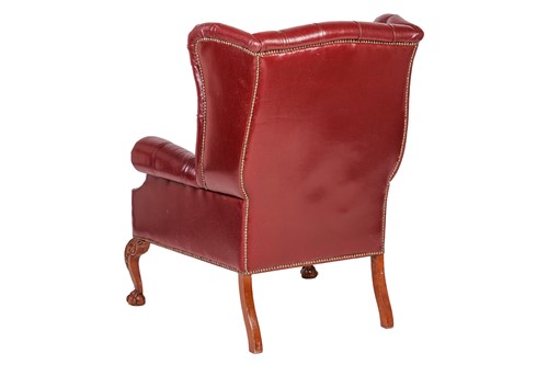 Lot 251 - A George III style deep buttoned hide fireside...