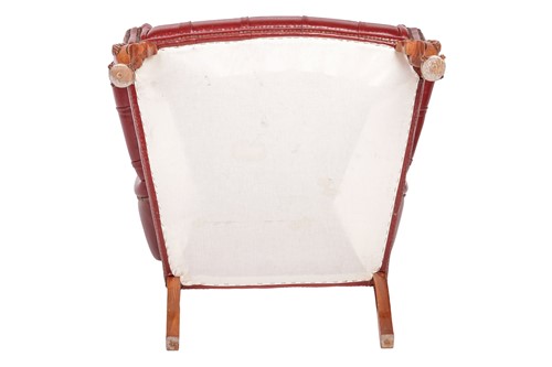 Lot 251 - A George III style deep buttoned hide fireside...