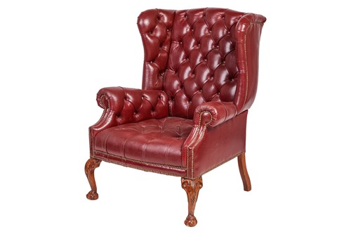 Lot 251 - A George III style deep buttoned hide fireside...