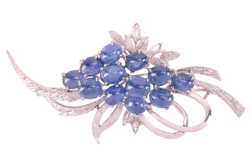 Lot 23 - A sapphire cabochon spray brooch, of foliate...