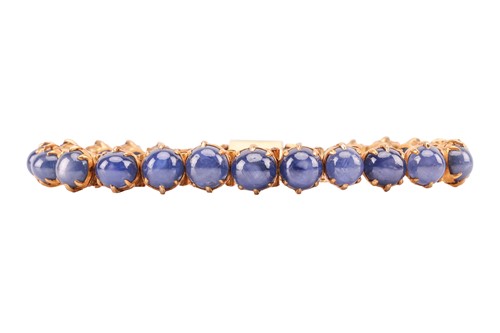 Lot 26 - A star sapphire line bracelet, claw-set with...