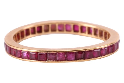 Lot 8 - A ruby-set eternity ring, channel-set with...