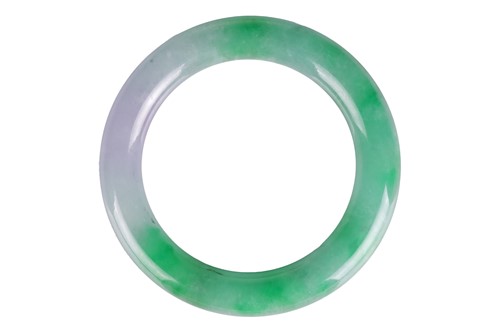 Lot 163 - A Chinese apple green/grey Jadeite bangle of...