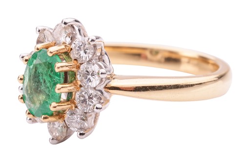 Lot 46 - An emerald and diamond cluster ring in 18ct...