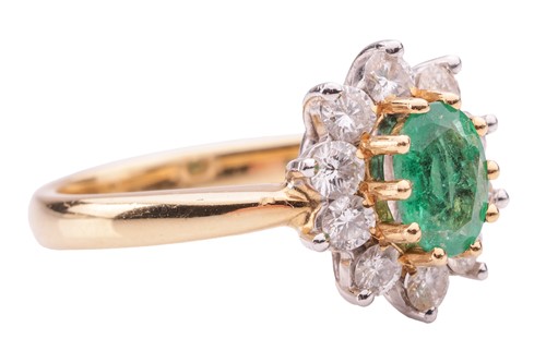 Lot 46 - An emerald and diamond cluster ring in 18ct...