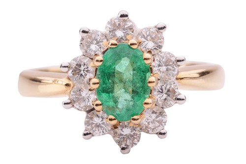 Lot 46 - An emerald and diamond cluster ring in 18ct...