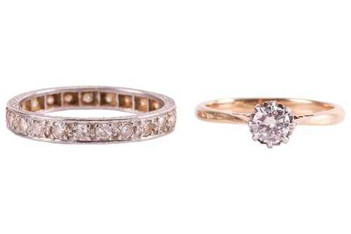 Lot 100 - A diamond solitaire ring and an eternity ring;...