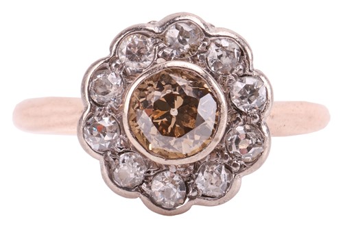 Lot 233 - A diamond daisy head cluster ring, featuring a...