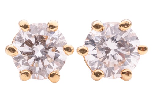 Lot 57 - A pair of diamond stud earrings, each six-claw...