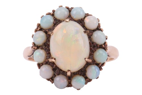 Lot 78 - An opal cluster ring, comprising an oval...