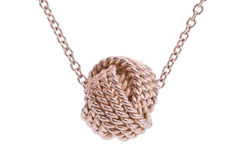 Lot 63 - Tiffany & Co. - a twisted knot pendant on...