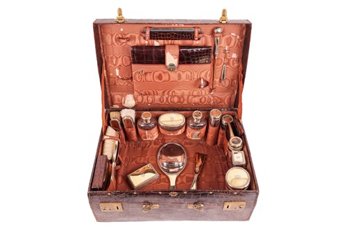 Lot 365 - A fitted crocodile case with silver gilt...