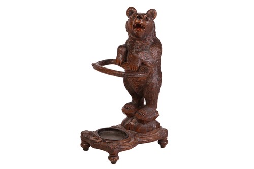 Lot 183 - A carved wood Black Forest stick stand,...