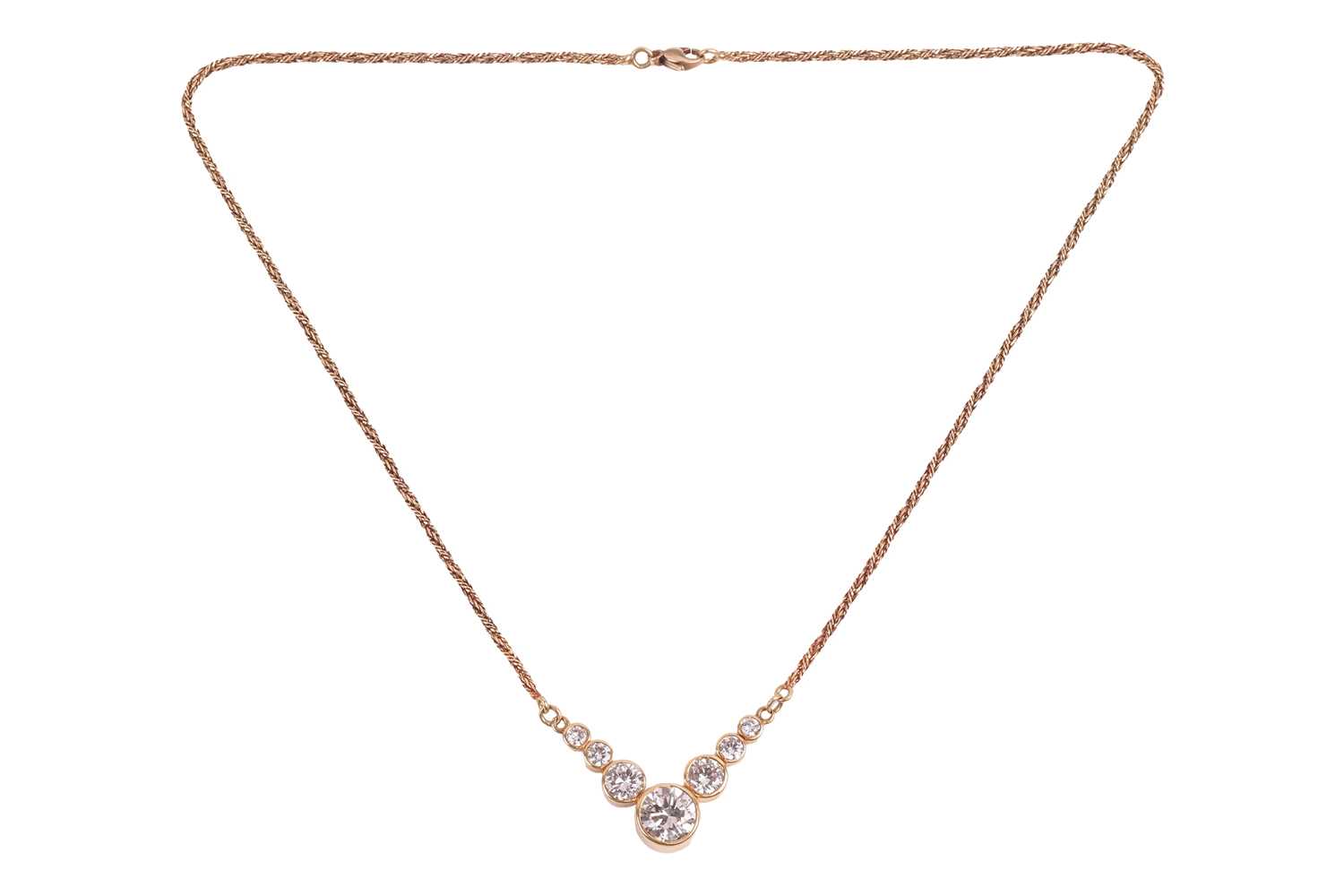 Lot 35 - A V-shaped diamond necklace, featuring seven...