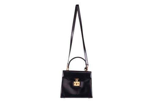 Lot 70 - A Gucci black leather handbag, of plain...