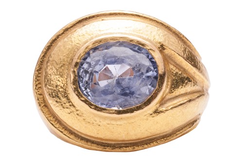 Lot 125 - A sapphire dress ring, centred with an...