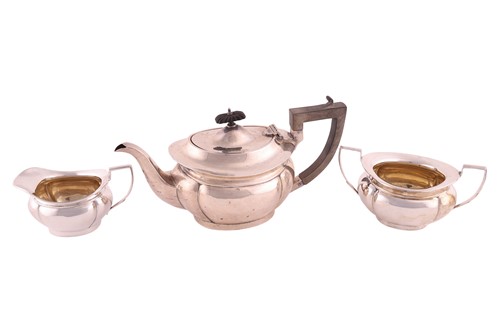 Lot 331 - A three piece silver teaset, of panelled oval...