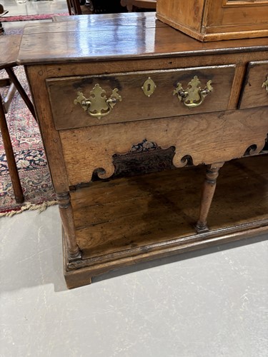 Lot 107 - A George III oak pot board dresser base with a...