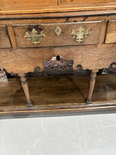 Lot 107 - A George III oak pot board dresser base with a...