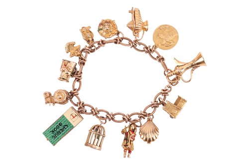 Lot 16 - A 9ct gold charm bracelet, comprising a cable...