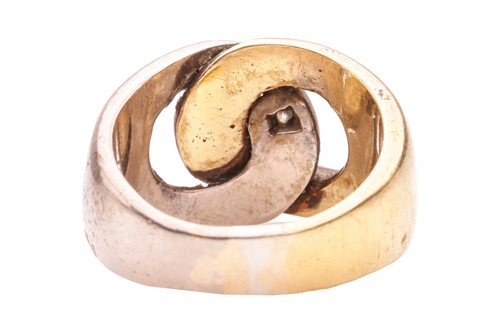 Lot 135 - A two-tone interlocking ring, highlighted with...