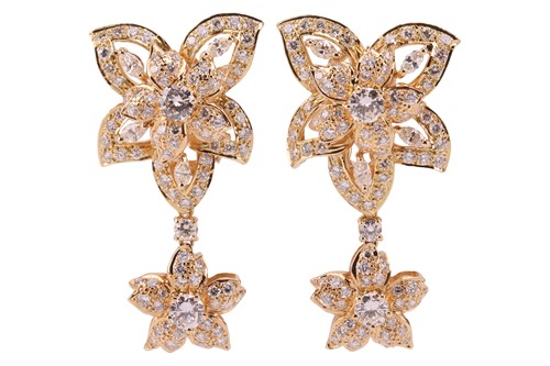 Lot 52 - A pair of diamond drop earrings, each pierced...