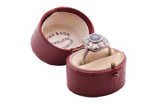 Lot 84 - A sapphire and diamond panel ring, the cushion-...