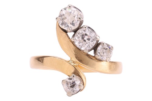 Lot A diamond bypass ring, set with four graduated...