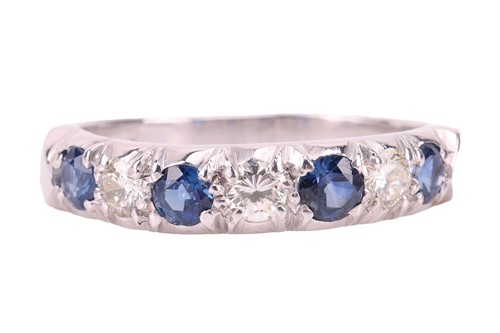 Lot 54 - A sapphire and diamond half-eternity ring in...