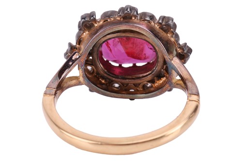 Lot 247 - A ruby and diamond cluster ring, centred with...